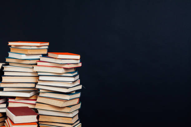 istock many stacks of educational books for learning preparation for college exams on a black background 1216990350