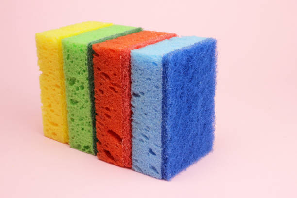 istock Colored sponges for dishes or home cleaning on a pink background 1216990419