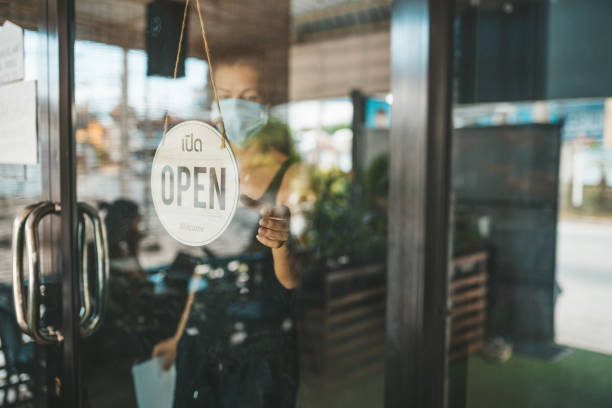 istock Store Owner in medical mask closed restaurant for quarantine 1216991285