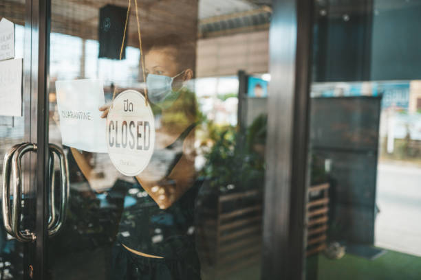 istock Store Owner in medical mask closed restaurant for quarantine 1216991286