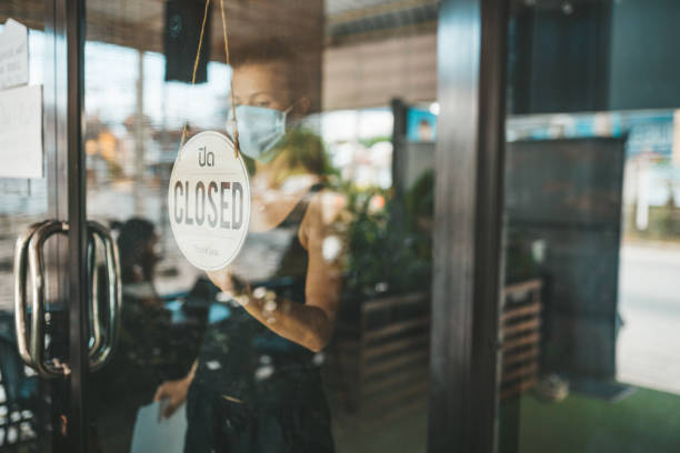 istock Store Owner in medical mask closed restaurant for quarantine 1216991299