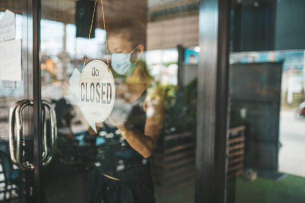 istock Store Owner in medical mask closed restaurant for quarantine 1216991310