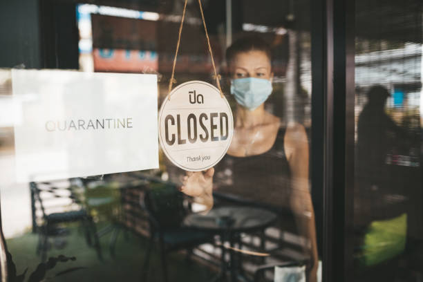 istock Store Owner in medical mask closed restaurant for quarantine 1216991314