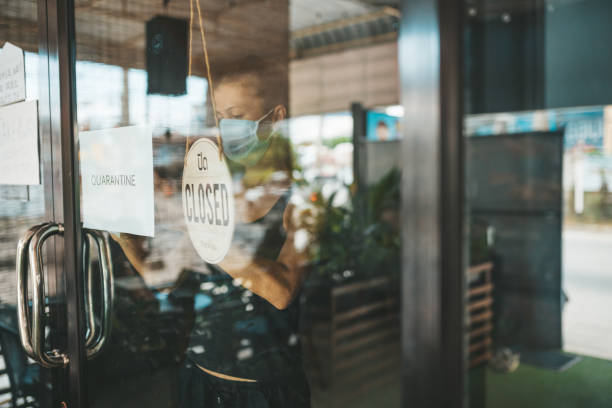 istock Store Owner in medical mask closed restaurant for quarantine 1216991388