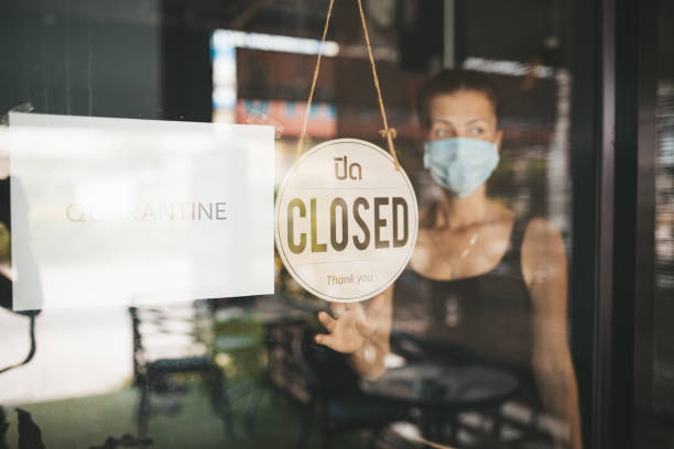 istock Store Owner in medical mask closed restaurant for quarantine 1216991393