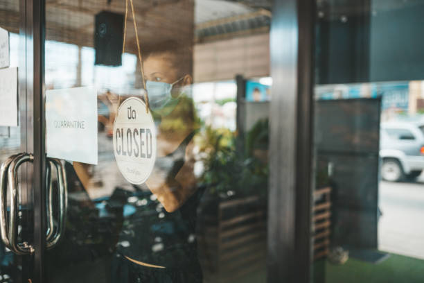 istock Store Owner in medical mask closed restaurant for quarantine 1216991396