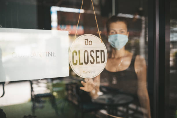 istock Store Owner in medical mask closed restaurant for quarantine 1216991462