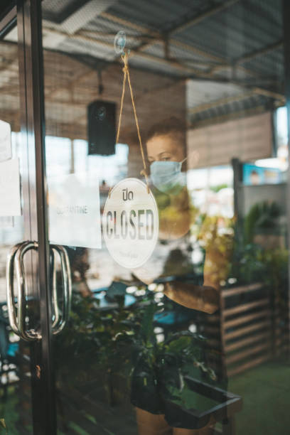 istock Store Owner in medical mask closed restaurant for quarantine 1216991470