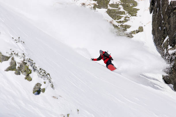 istock Snowboarder turning in deep powder 1216992024
