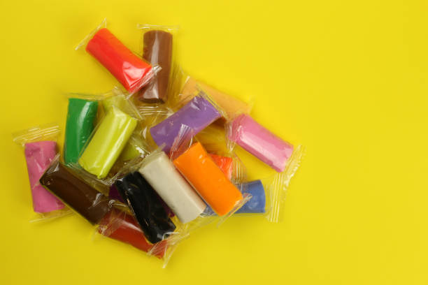 istock colorful clay, plasticine on a yellow background 1216992058