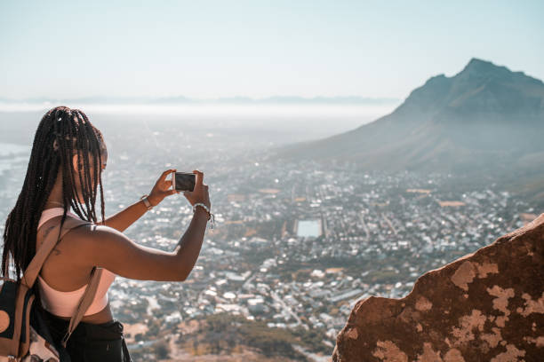 Making a memory. Young woman making the photo of Cape Town, South Africa. africa travel stock pictures, royalty-free photos & images