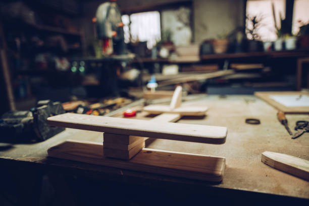 istock Carpenters working desk with airplane model 1216994813