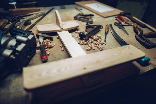 istock Carpenters working desk with airplane model 1216994870