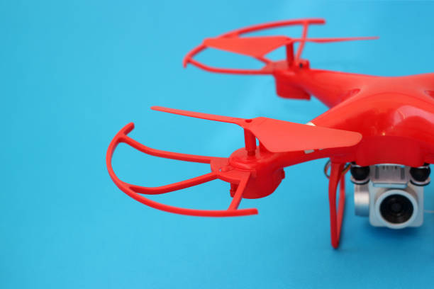 istock drone, a quadrocopter with a camera on a blue background 1216995028