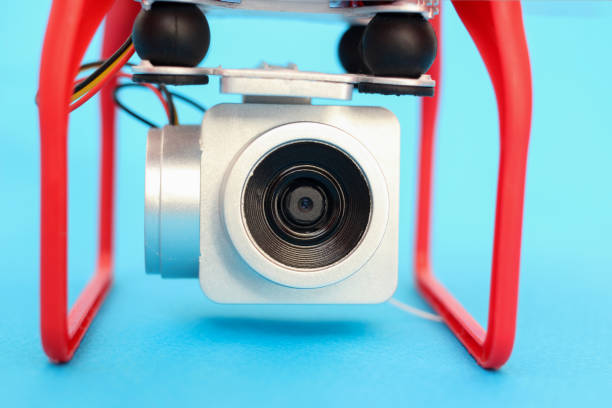istock Camera of a drone, a quadrocopter close-up on a blue background 1216995033