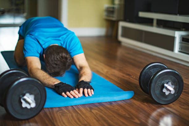 istock Young adult man doing sport training at home during quarantine 1216996568