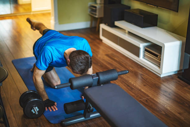istock Young adult man doing sport training at home during quarantine 1216996641
