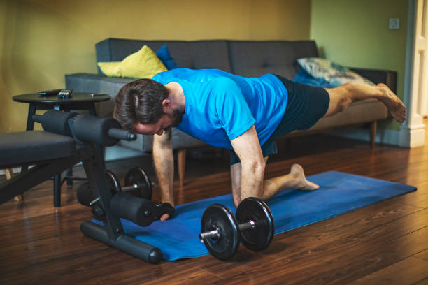istock Young adult man doing sport training at home during quarantine 1216996672