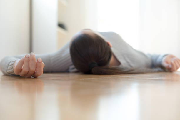 自宅で床に横たわっている女性 - 気絶する ストックフォトと画像