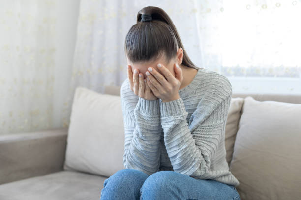 istock Depressed woman at home 1216997598