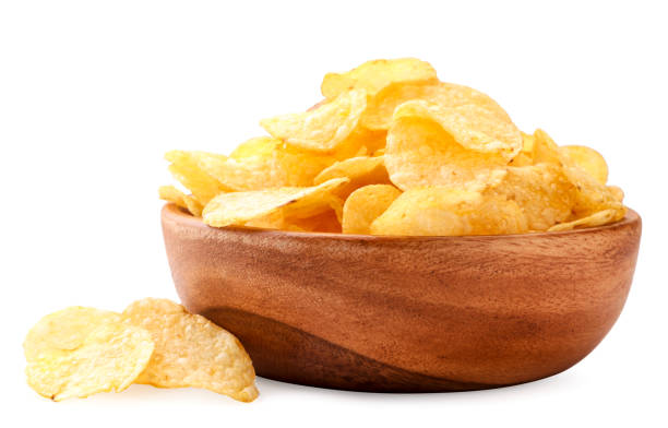 Potato chips in a wooden plate on a white background. Isolated Potato chips in a wooden plate close-up on a white background. Isolated potato chip photos stock pictures, royalty-free photos & images