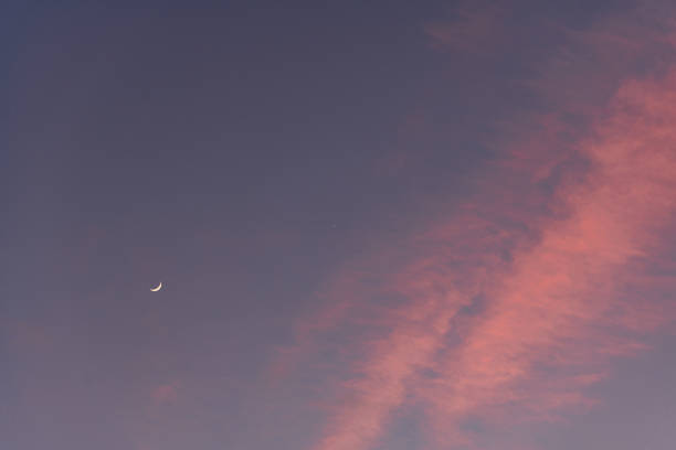 istock The crescent moon with pink clouds nearby 1217005207