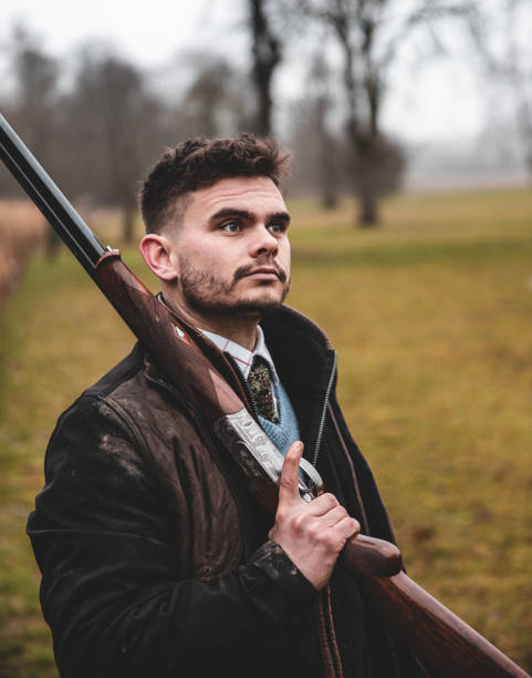 istock Hunter resting shotgun on shoulder looking into distance 1217005944