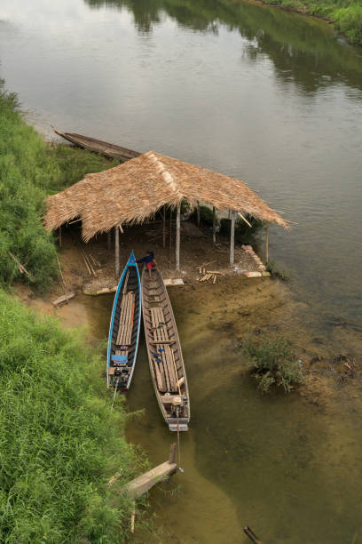 istock YE, MYANMAR - DECEMBER 9, 2018: Unidentified man relaxing in a long tail boat on the Ye River. 1217006426