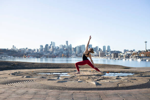 istock Young Caucasian Woman Extended Triangle Pose Outside Alone in City 1217007689