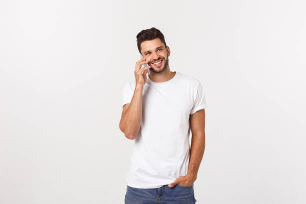 istock Smiling guy talking on a mobile phone isolated on white background. 1217008147