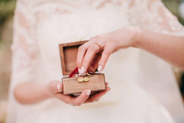 istock bride holding wedding rings 1217009214