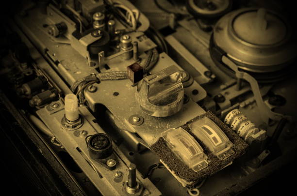 Old reel tape recorder. Detailed view of the internal structure of an analog tape recorder. Dusty audio device parts. Top view at an angle. Selective focus.