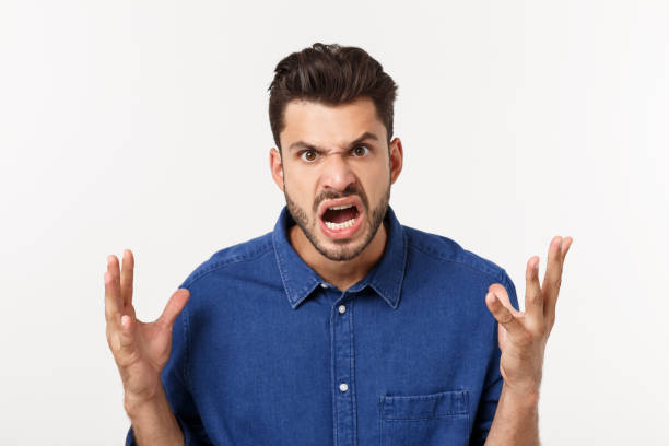 istock young office worker mad by stress screaming isolated on white. 1217010385