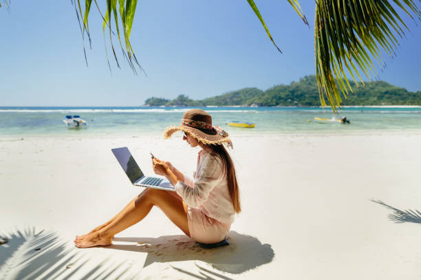 istock Woman freelancer on the beach 1217010598
