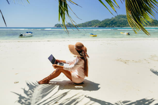 istock Woman freelancer on the beach 1217010599