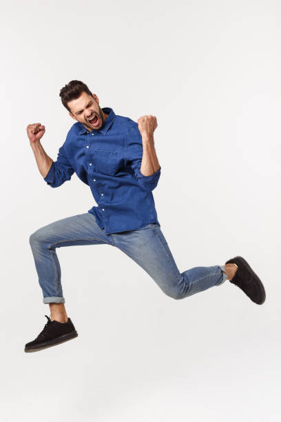 istock An attractive athletic businessman jumping up against white background 1217010810