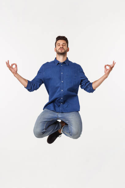 istock Portrait peaceful businessman meditating on white background 1217010830