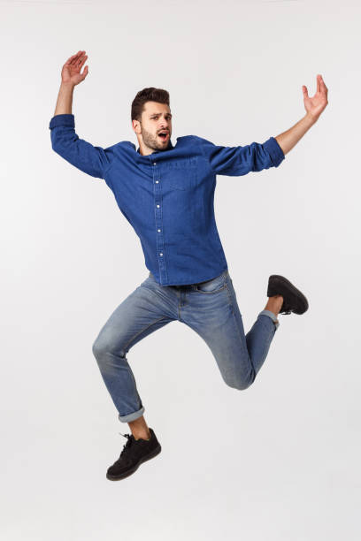 istock An attractive athletic businessman jumping up against white background 1217010852