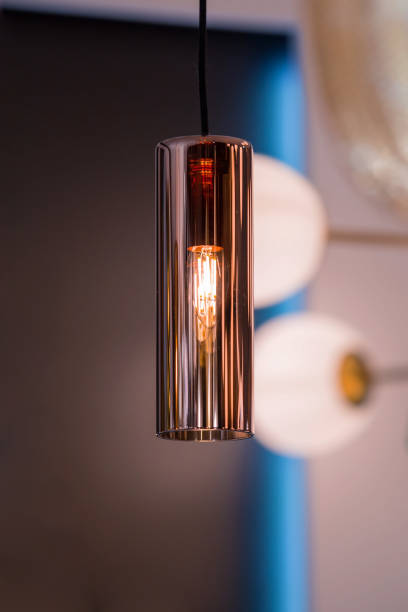 istock Modern streamlined copper chandelier. Glass shaped pendant lamp interesting form 1217011824