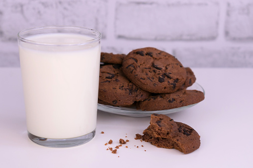 milk and chocolate chip cookies on a white background.