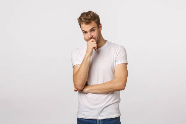 istock Troubled and shocked, indecisive blond handsome boyfriend, dont know what do, facing difficult problem, look away nervous and distressed, losing patience temper, touch lips, stand white background 1217014300