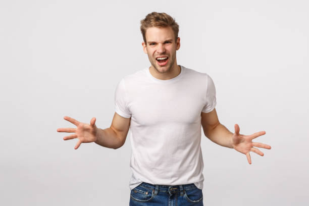 istock Expressive and confident, young passionate blond caucasian guy showing strength, power, yelling and spread hands sideways like playing rugby, catching something, standing white background 1217014346