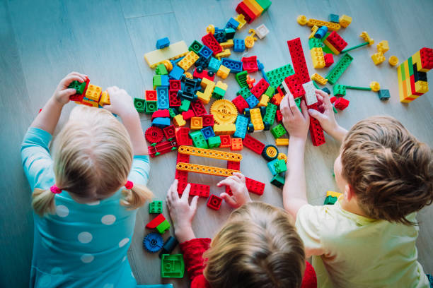 istock kids playing with plastic blocks, staying home, learning and play 1217015721