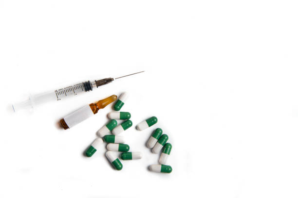istock Coronavirus 2019-nCoV outbreak. Pills and syringe on a white isolated background. 1217015989