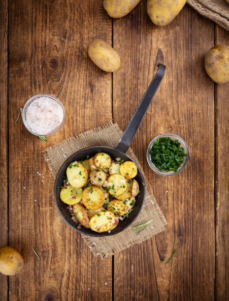 istock Portion of Fried Potatoes on an old wooden table (selective focus; close-up) 1217016835