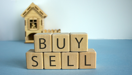 To buy or sell a house? Cubes form the words 
