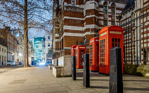 London, UK - Aug 14, 2023: Iconic, classic red double decker bus driving, turning on intersection with people sitting, eating during Afternoon Tea Tour