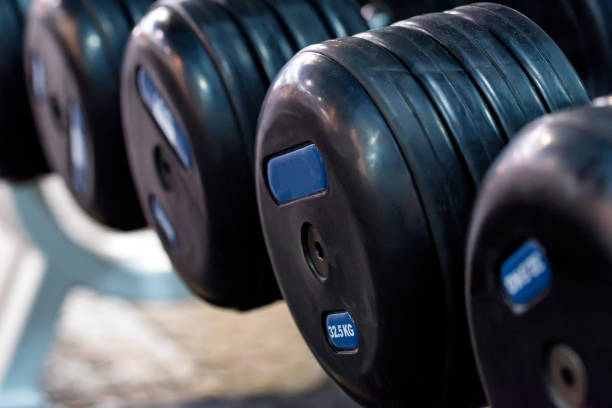 istock Closeup image of several black chrome dumbbells 1217017092