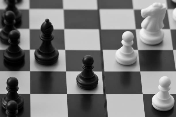 istock Black and white chessmen on chessboard 1217017181