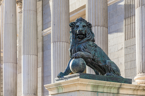 Lion sculpture by the Congress of Deputies - Congreso de Los Diputados Spanish Parliament, Palacio de las Cortes, Madrid. Translation: Cast of cannons taken to the enemy in the War of Africa in 1860